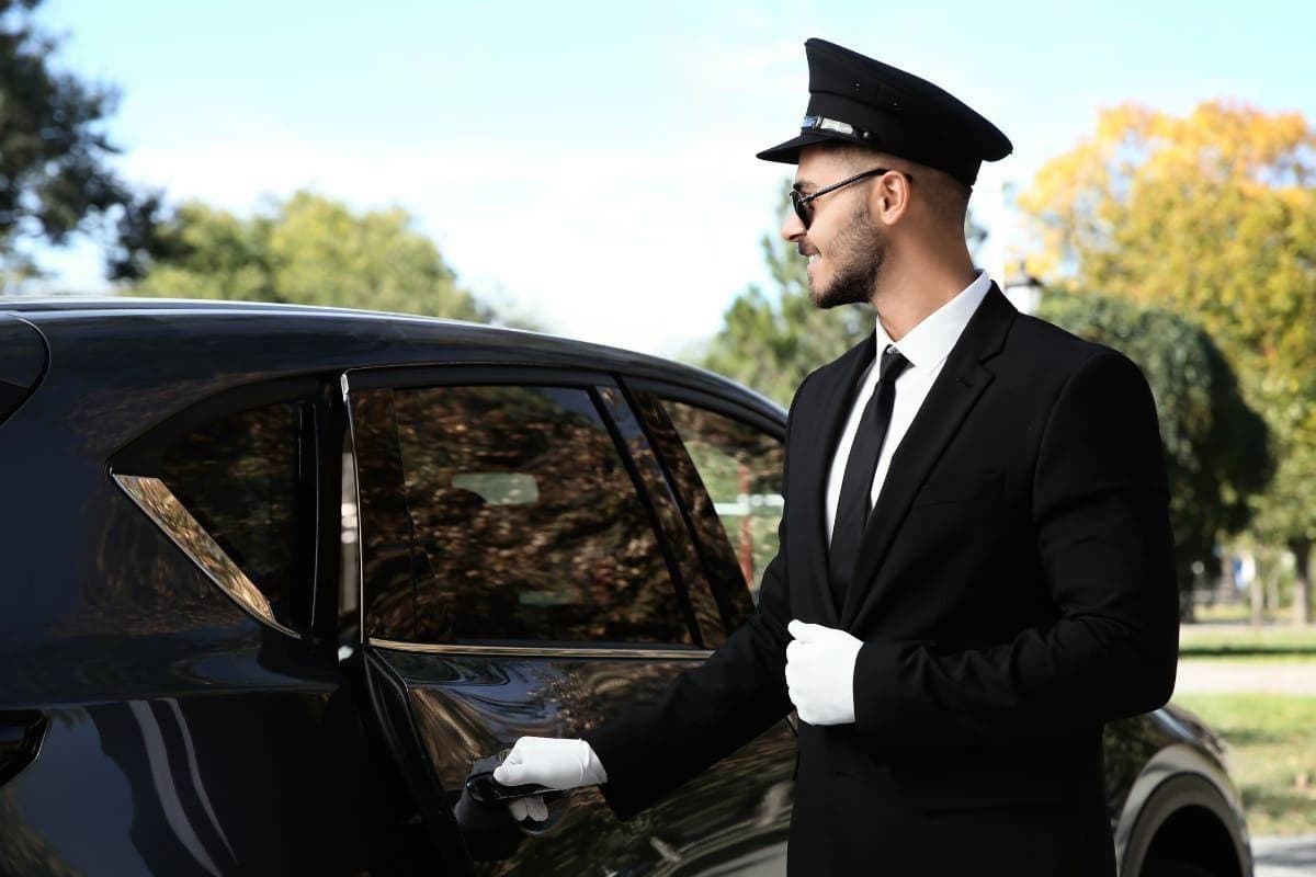 Luxury chauffeur service with the Jeddah skyline in the background